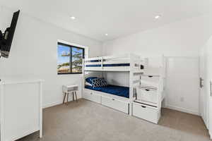 Bedroom with light carpet and recessed lighting