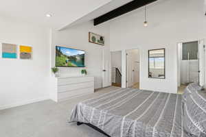 Bedroom with carpet flooring, beam ceiling, high vaulted ceiling, connected bathroom, and recessed lighting