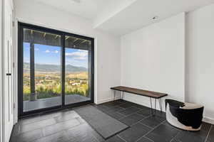 Doorway featuring a mountain view and baseboards