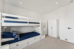 Bedroom featuring light colored carpet and recessed lighting