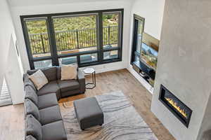 Living room with a large fireplace and light wood finished floors