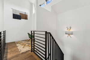 Staircase featuring wood finished floors and baseboards