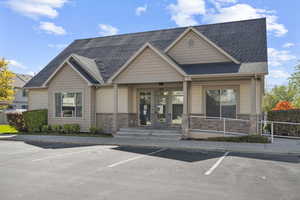 View of building exterior with uncovered parking