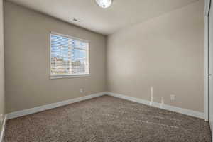 Unfurnished room featuring carpet floors and baseboards