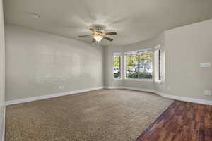 Unfurnished room featuring a ceiling fan and wood finished floors