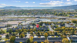 Aerial perspective of suburban area featuring a mountain backdrop and a highway