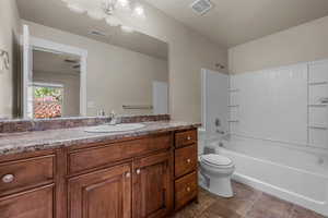 Bathroom with vanity and washtub / shower combination