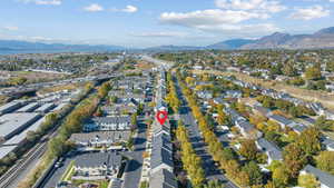 Aerial overview of property's location featuring mountains and nearby suburban area