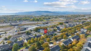 Aerial view of property's location featuring a mountain backdrop and nearby suburban area