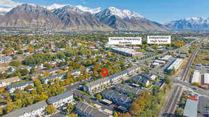 Aerial view of property's location featuring a mountainous background