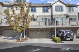 View of property with driveway and a garage
