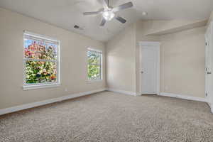 Unfurnished bedroom with lofted ceiling, light colored carpet, and ceiling fan