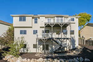 Rear view of house with a patio, a deck, and stairs