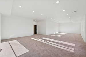 Spare room featuring recessed lighting and light carpet