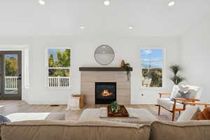 Living room featuring recessed lighting, wood finished floors, and a fireplace
