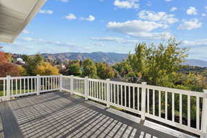 Wooden terrace featuring a mountain view