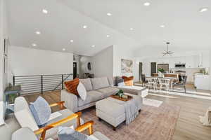 Living area featuring recessed lighting, light wood-style flooring, and vaulted ceiling