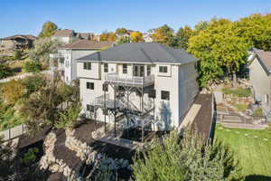 Rear view of property with a fenced backyard, a patio, and stairway