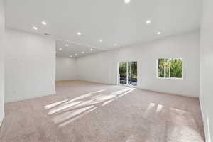 Spare room with recessed lighting and light carpet