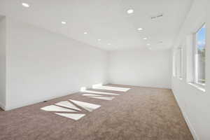 Spare room with recessed lighting and light colored carpet