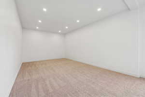 Spare room with recessed lighting and light carpet
