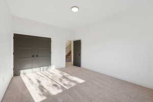 Unfurnished bedroom with a closet and carpet