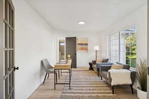 Living area with light wood-style flooring and an office area