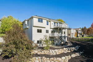 Rear view of house featuring a patio area, a balcony, and stairway