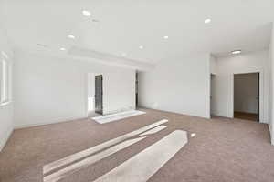 Empty room featuring light carpet and recessed lighting
