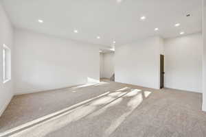 Spare room featuring recessed lighting and light colored carpet