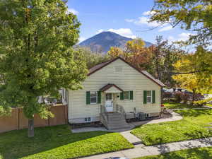 Bungalow-style home with a front yard and a mountain view