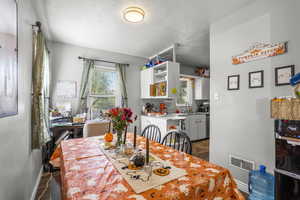 Dining space with a textured ceiling and baseboards