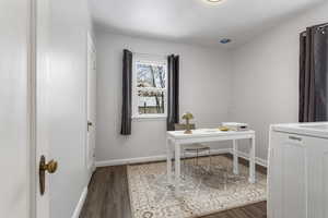 Home office featuring washer / clothes dryer and dark wood-type flooring