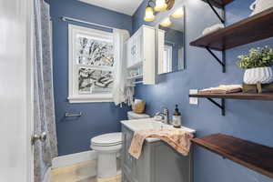 Full bathroom with vanity and curtained shower