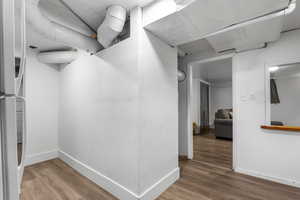 Corridor with wood finished floors and baseboards