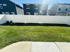 Fenced backyard with a residential view