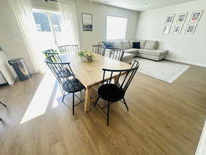 Dining area featuring light wood-style flooring and a textured ceiling