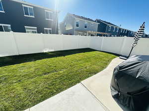 Fenced backyard with a residential view and a patio area