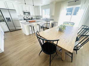 Dining space with light wood-type flooring