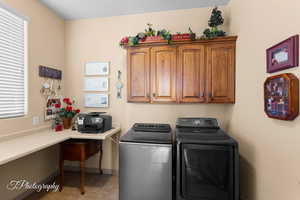 Washroom with separate washer and dryer, cabinet space, and light tile patterned floors