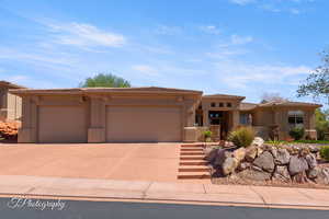 View of front of home with driveway, stucco siding, an attached garage, and a tile roof