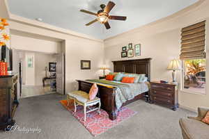 Bedroom with light colored carpet and a ceiling fan