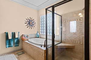 Full bathroom featuring a shower stall, a bath, and tile patterned floors