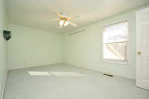 Unfurnished room featuring carpet flooring and ceiling fan