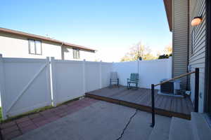 Fenced backyard featuring a deck