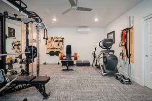 Basement exercise room with a ceiling fan, recessed lighting, and carpet flooring