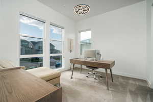 Carpeted office space featuring baseboards
