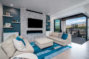 Living room featuring wood finished floors, a fireplace, and recessed lighting