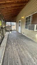 Wooden terrace featuring cooling unit