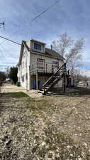 Back of house with stairway and a deck